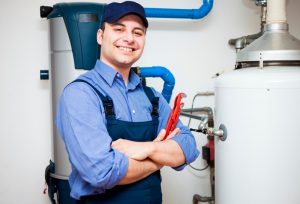 plumber-standing-next-to-water-heater