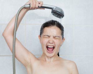 young-woman-in-shower-looking-surprised