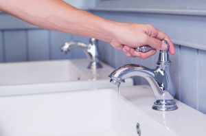 hand-on-bathroom-sink-faucet