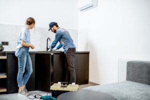 plumber-helping-homeowner-with-kitchen-sink