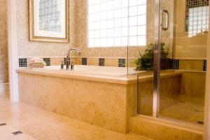 Modern bathroom with a large soaking tub, glass shower, and two large windows with natural lighting.